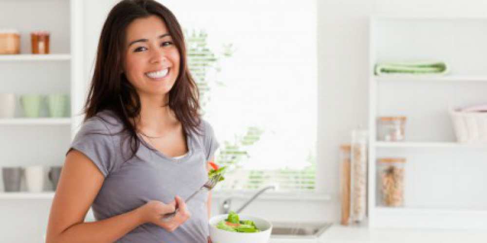 a woman eating a healthy salad