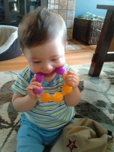 a baby using a teething ring
