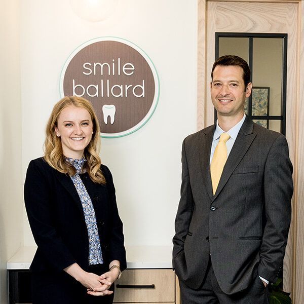 Our Seattle dentists standing next to Smile Ballard logo
